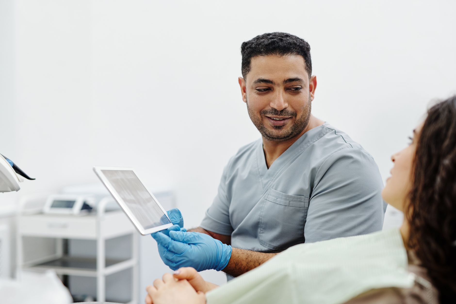 nurse showing a printed health handout to an older patient in a clinic