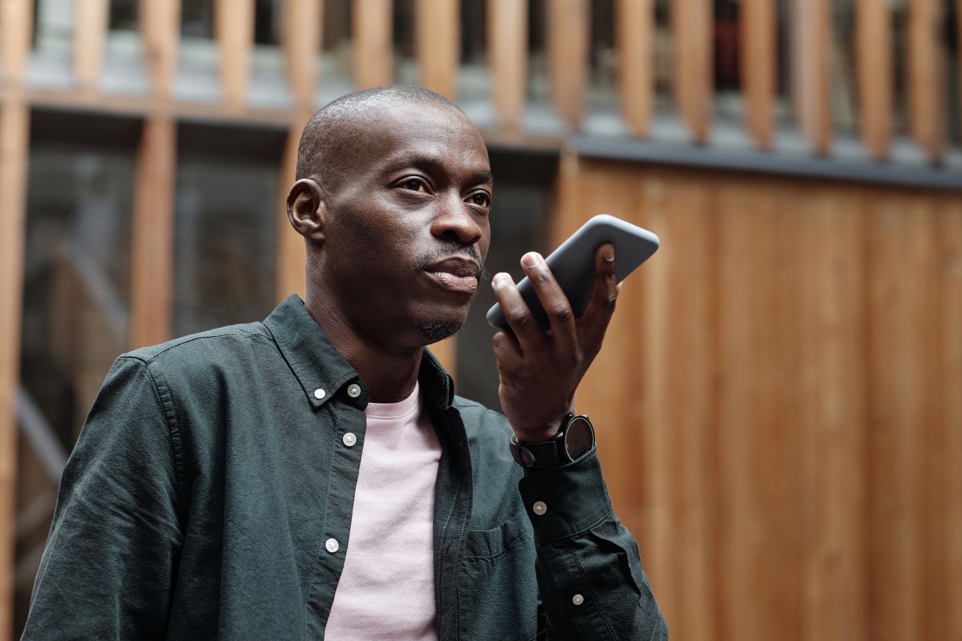 Person holding a smartphone with a Google AI assistant interface