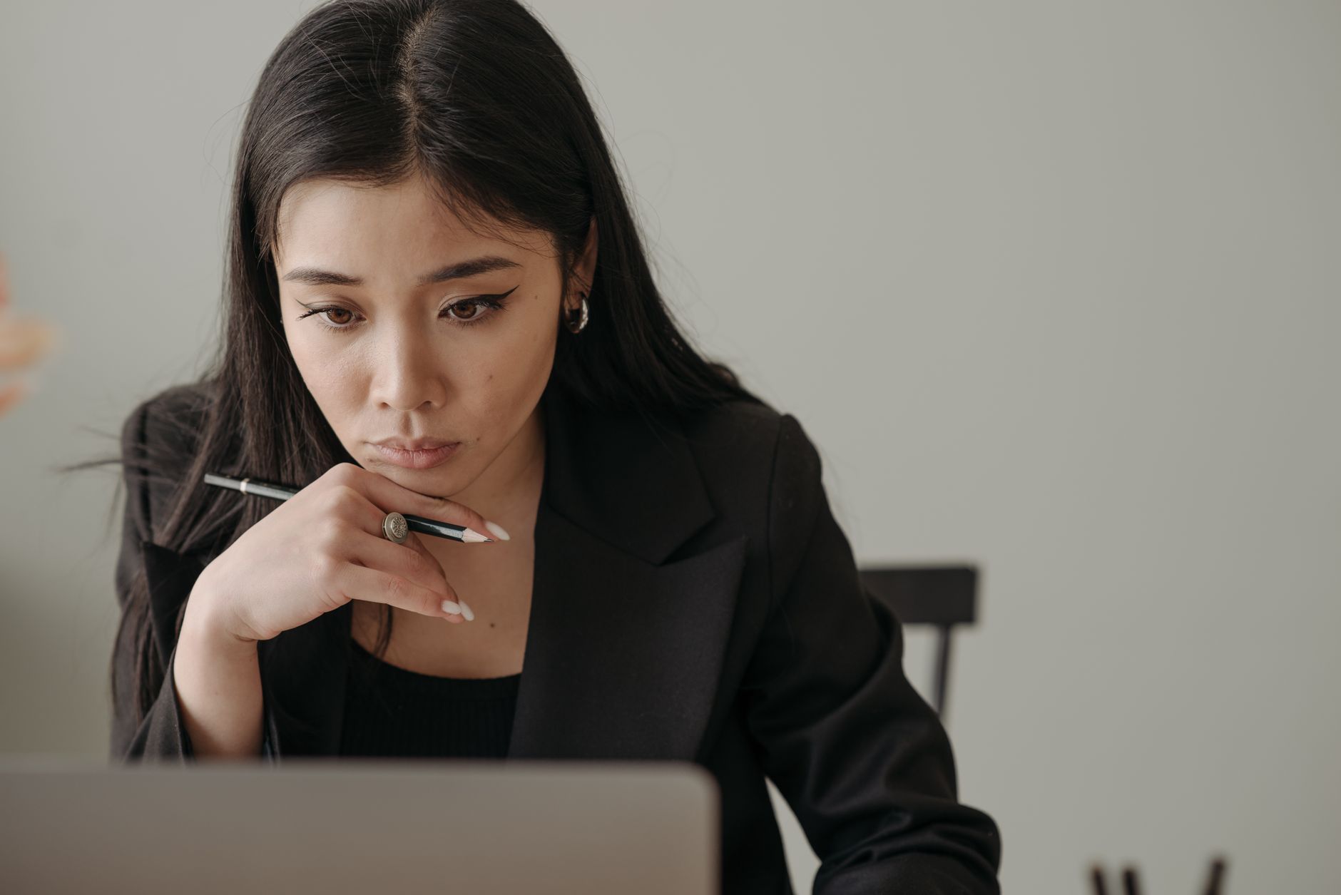 A person carefully refining a prompt on a laptop in a quiet room.